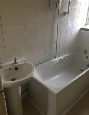 Bathroom bath with overhead shower